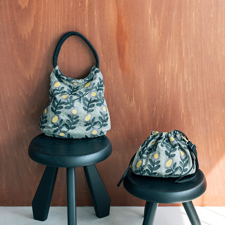 【商品写真】キッピスの人気の花柄「Lentokukka」を丁寧に表現した、コロンとした丸いシルエットのクラフト刺しゅうバッグ。やわらかなくすみグリーンをベースに、深いグリーンの葉模様と、グレーの花びらにやさしい黄色の花芯が刺繍されています